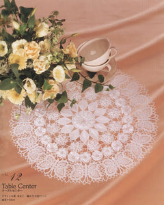 Round crochet table center with flower motifs and butterflies