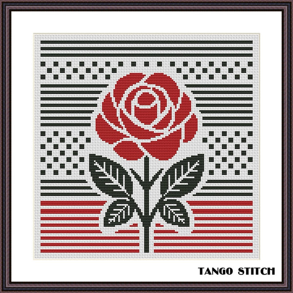 Cross-stitched design of a red rose with black leaves on a white background, featuring the brand 'Tango Stitch'. Red rose abstract geometric cross stitch pattern, Tango Stitch
