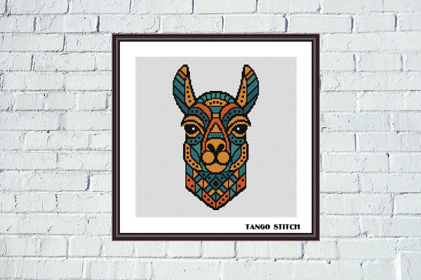 Framed cross-stitch pattern of a llama's face on a white brick wall. Llama bright geometric cross stitch pattern - Tango Stitch