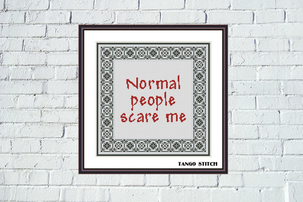 Normal people scare me funny sarcastic cross stitch pattern - Tango Stitch. Framed cross-stitch art with text 'Normal people scare me' on a white brick wall background.