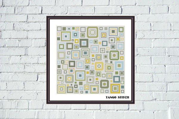 Framed geometric pattern art on a white brick wall. Geometric squares abstract cross stitch design, Tango Stitch