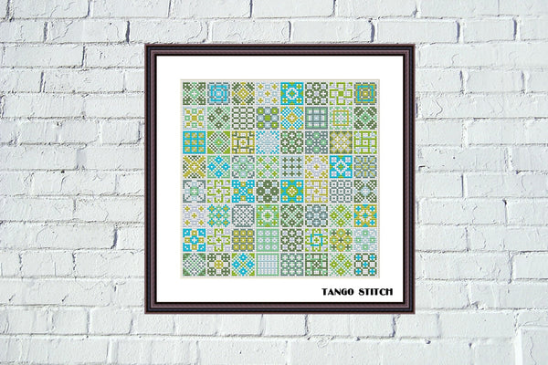 Framed patterned artwork titled 'Tango Stitch' on a white brick wall. Granny squares yellow green cross stitch sampler pattern - Tango Stitch